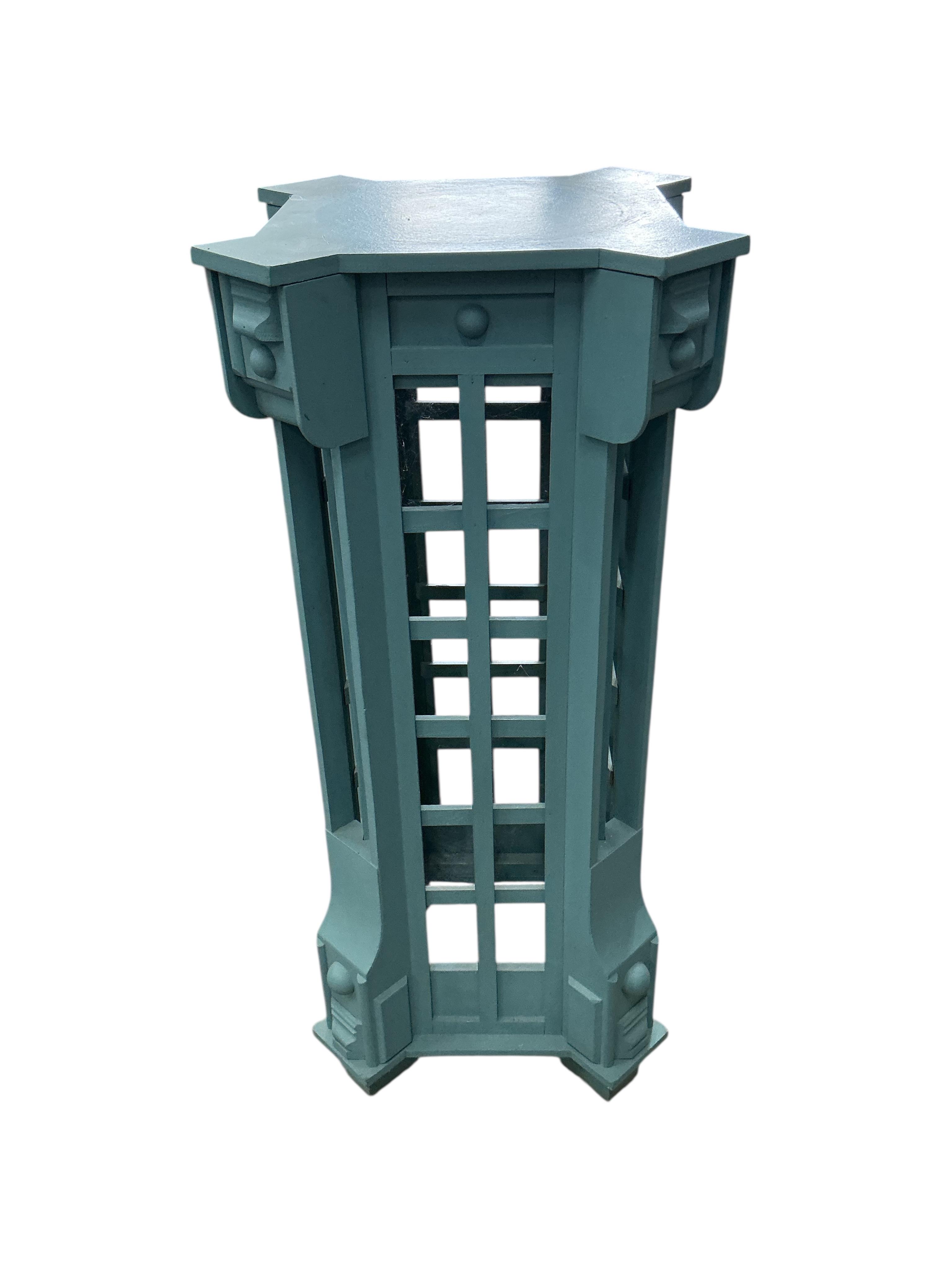 A green painted wood urn and pedestal, height 175cm, Provenance: The late Kenneth Turner (1936-2025), celebrity florist, designer and perfume retailer, he received the Royal Warrant from the Prince of Wales in the 1990s